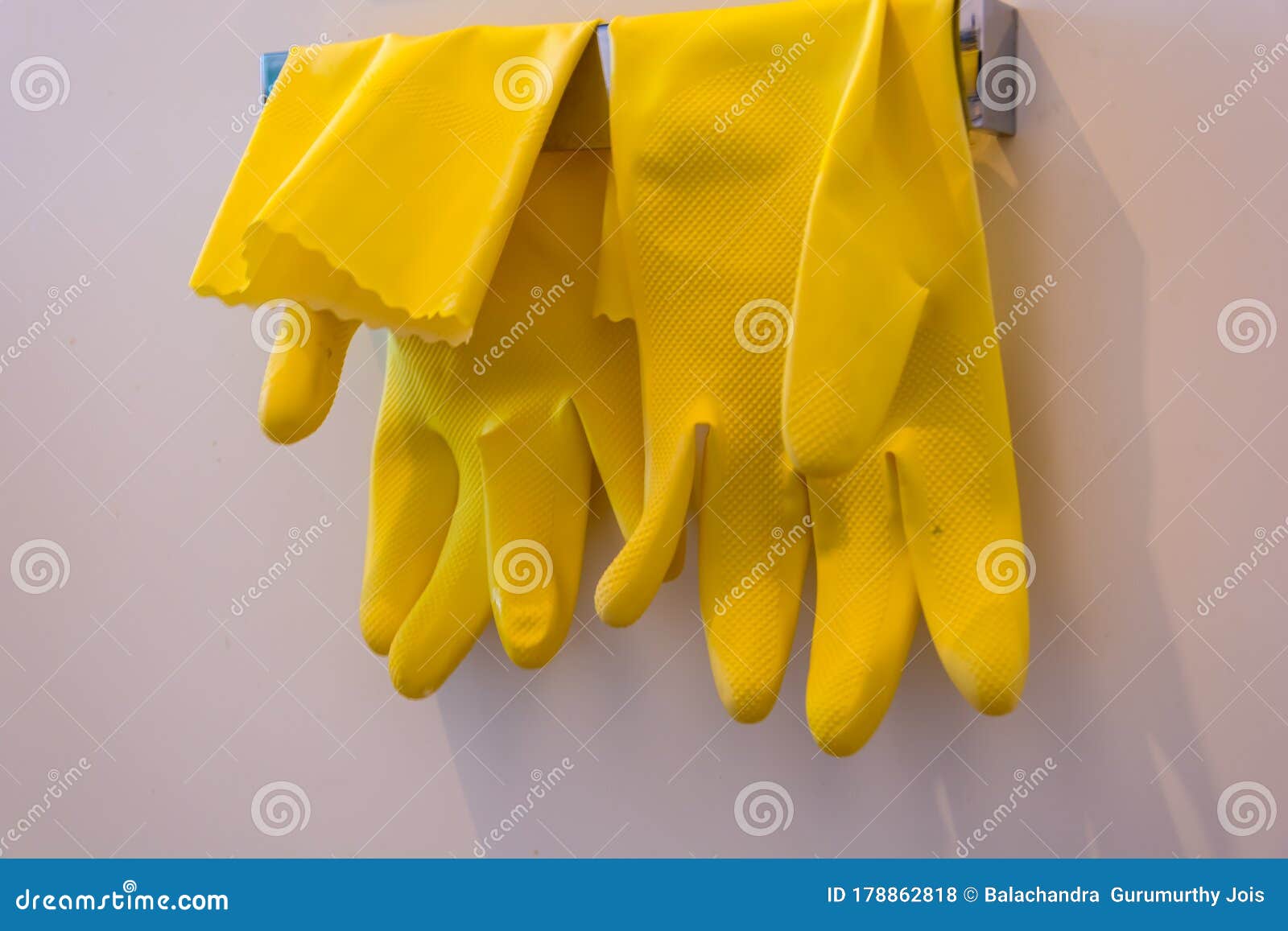 pair of yellow hand gloves hanging after cleanign home