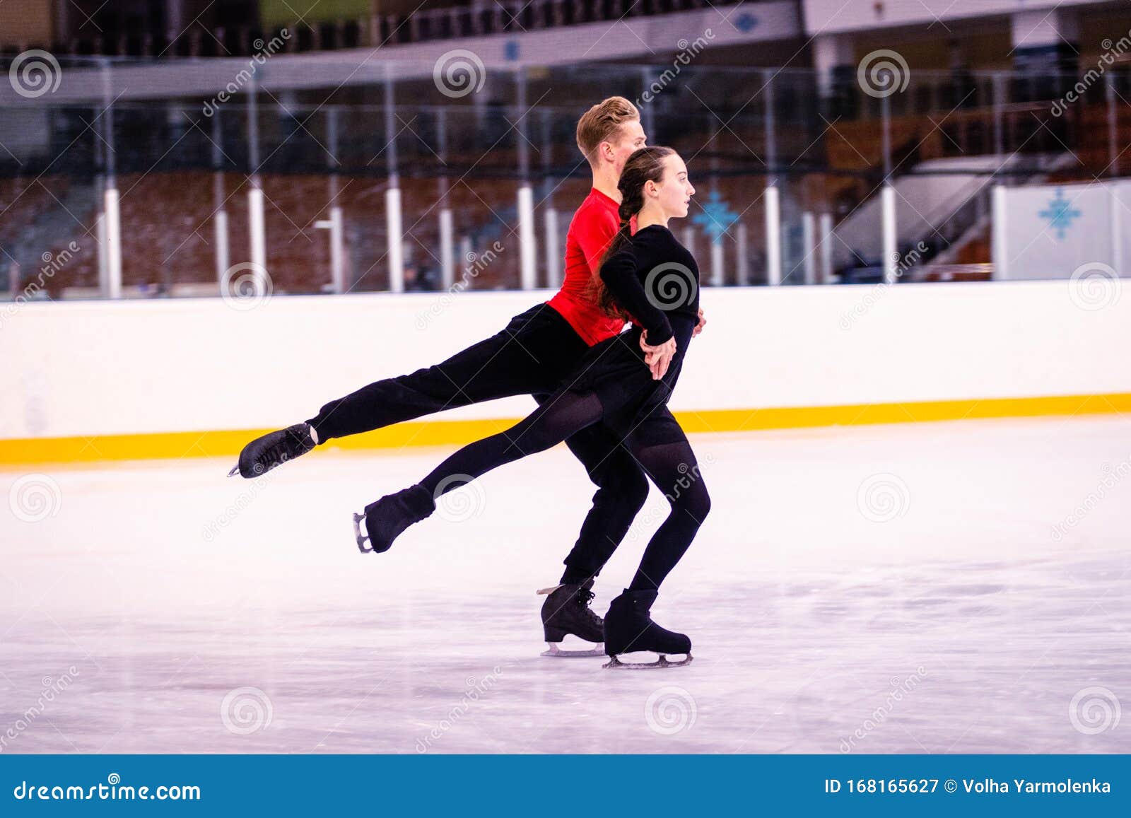 A Pair of Young Athletesskaters Performs Parallel Glide. Stock Image Image of athletesskaters