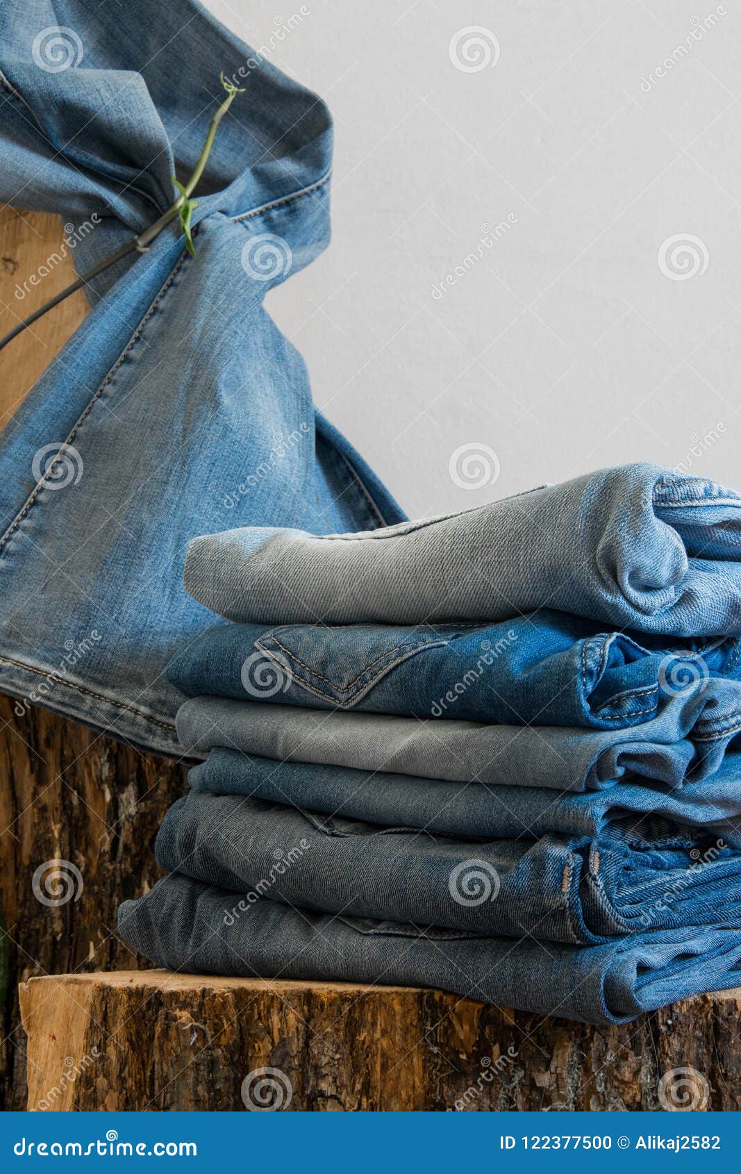 Pairs of Jeans Hanging on an Old Wooden Trunk, White Background Stock ...