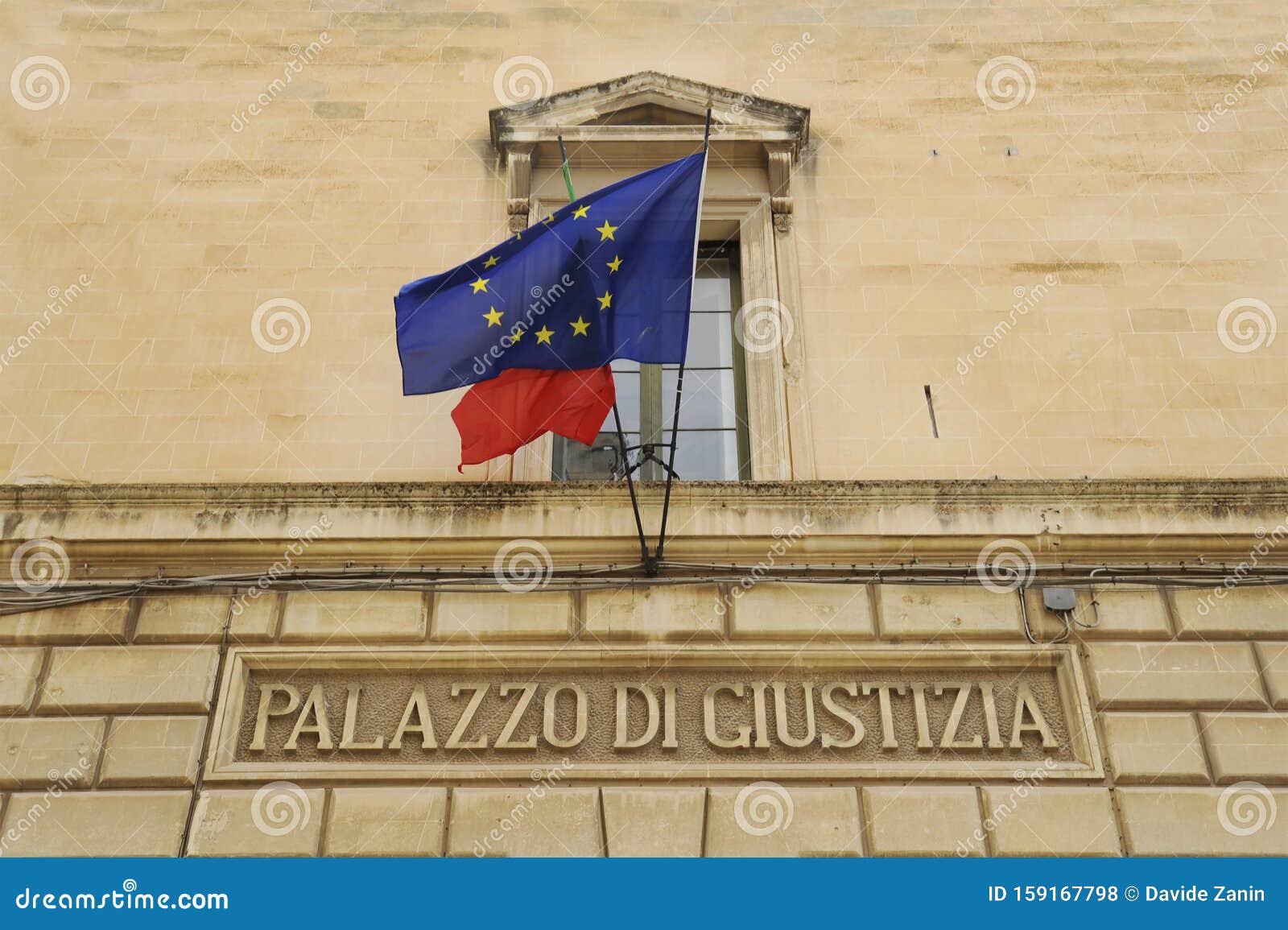 palazzo di giustizia. palace of justice in lecce, italy. former convent of the jesuits. european and italian flag on facade