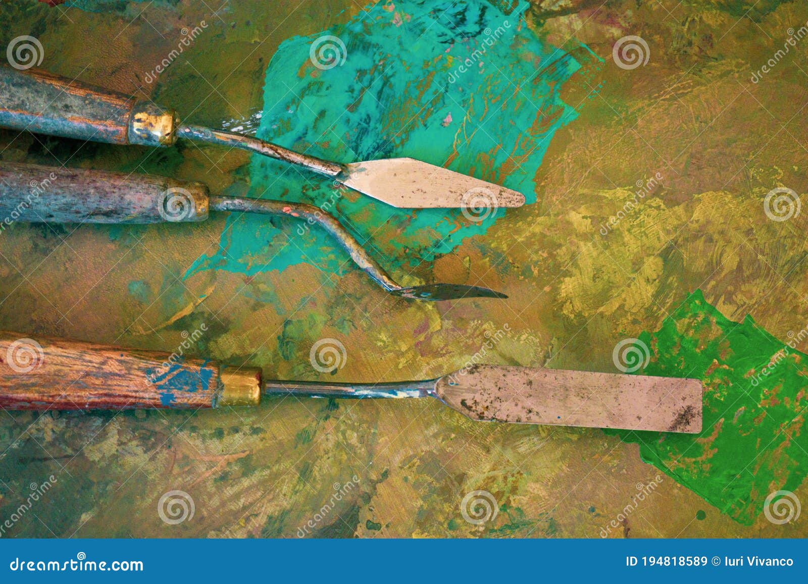 Palette Knifes or Painter`s Tools in a Used Painter`s Palette with Spots of Color. Painter`s
