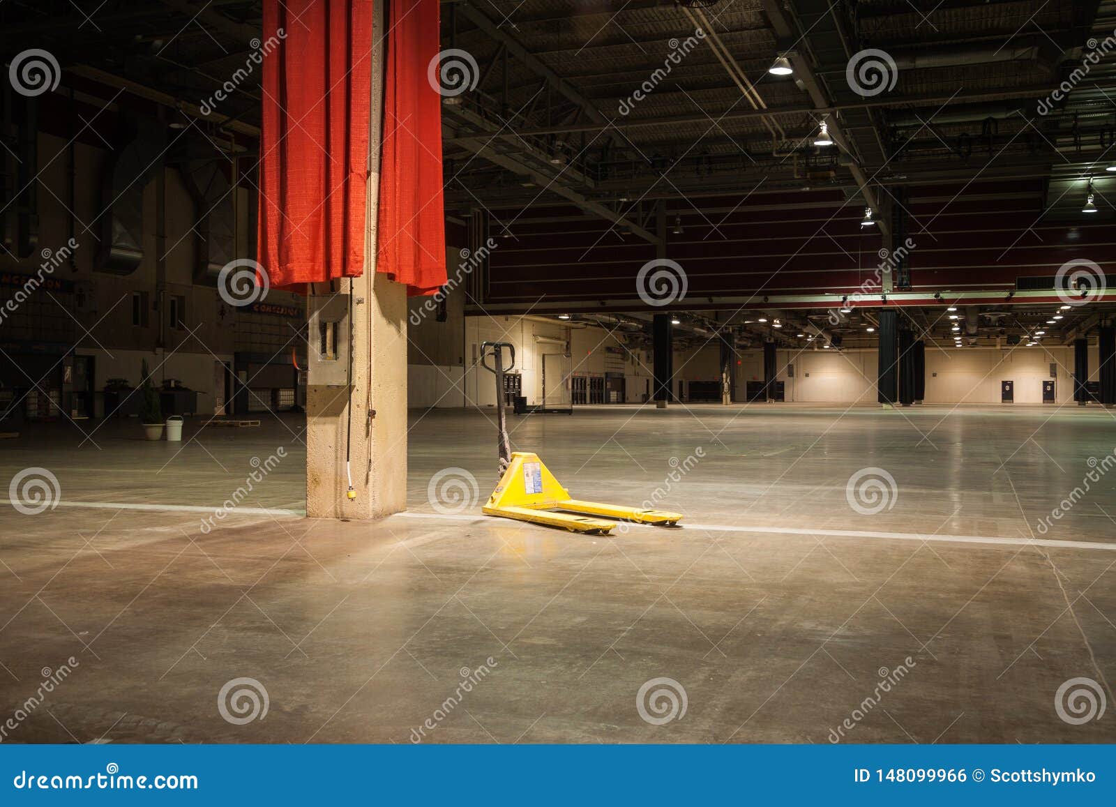 pallet jack sits in empty convention hall