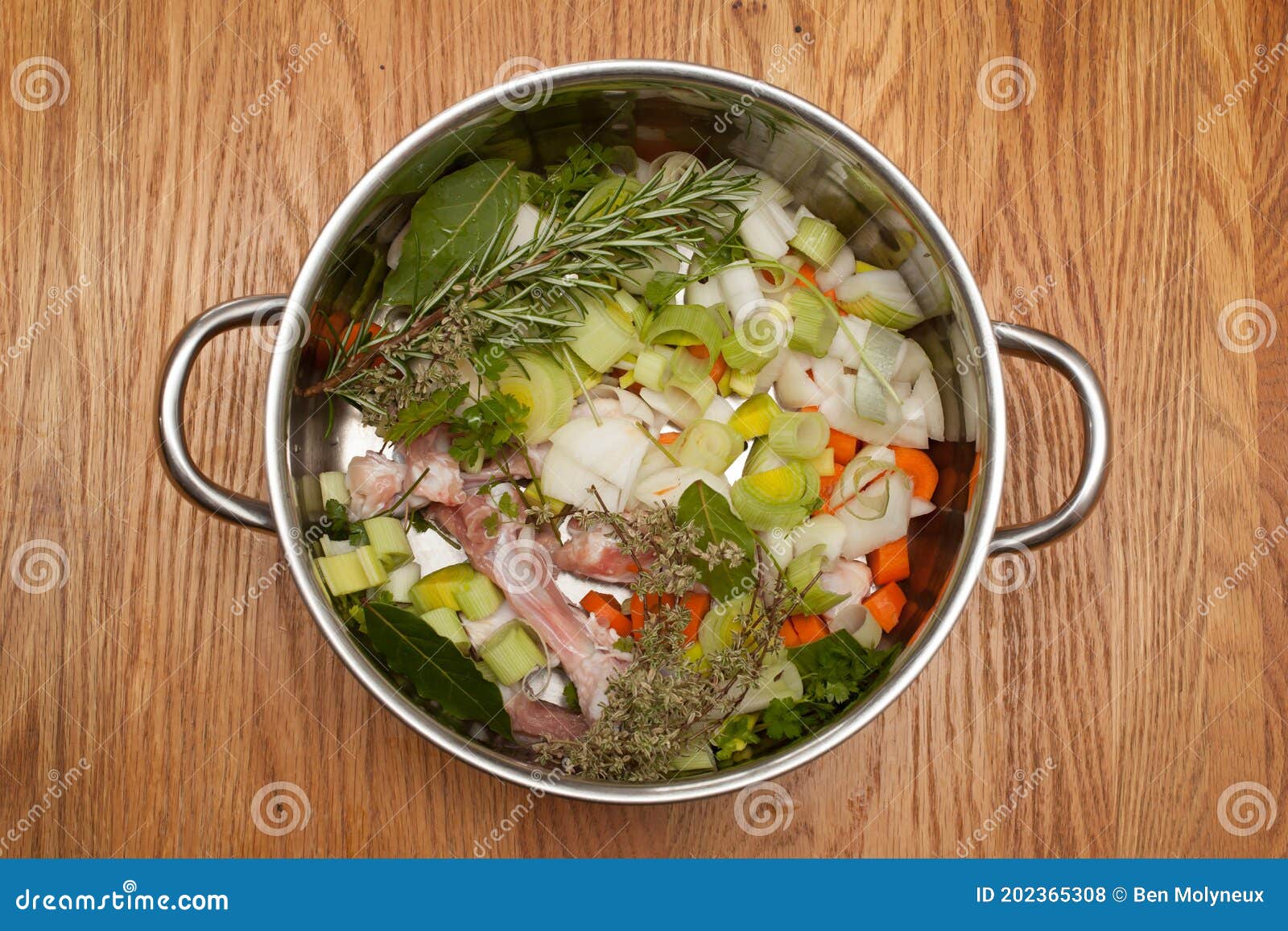 A Pan Full of Chicken Bones, Vegetables and Herbs Ready To Make a
