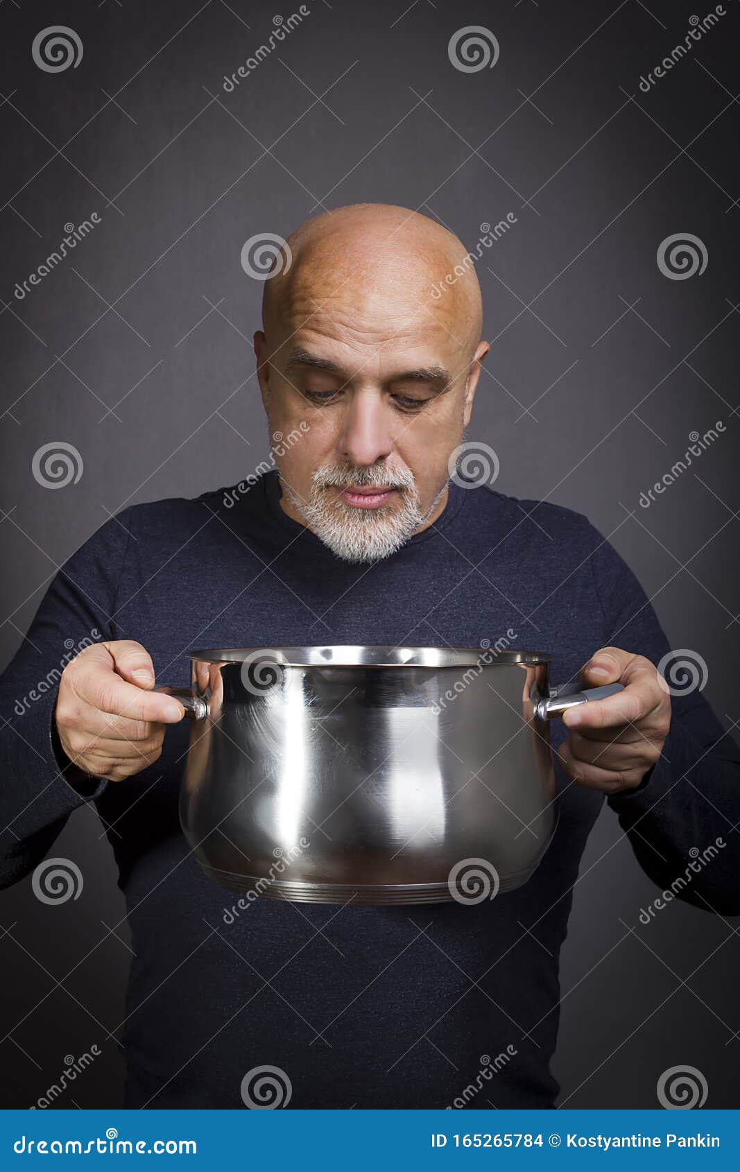 Pan in the hands of a man stock photo. Image of saucepan 165265784
