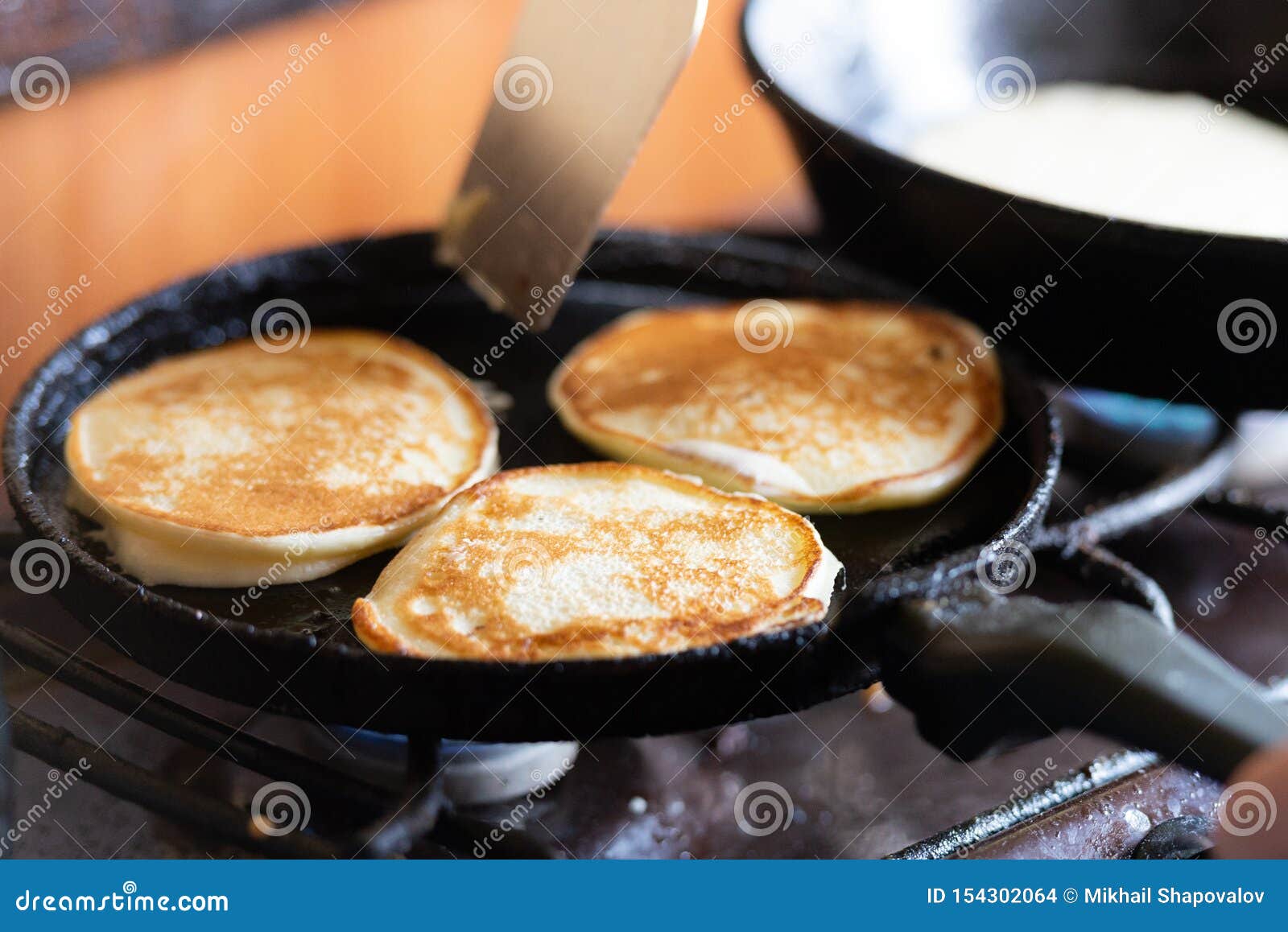 Pancakes in the pan stock photo. Image of iron, preparation 154302064