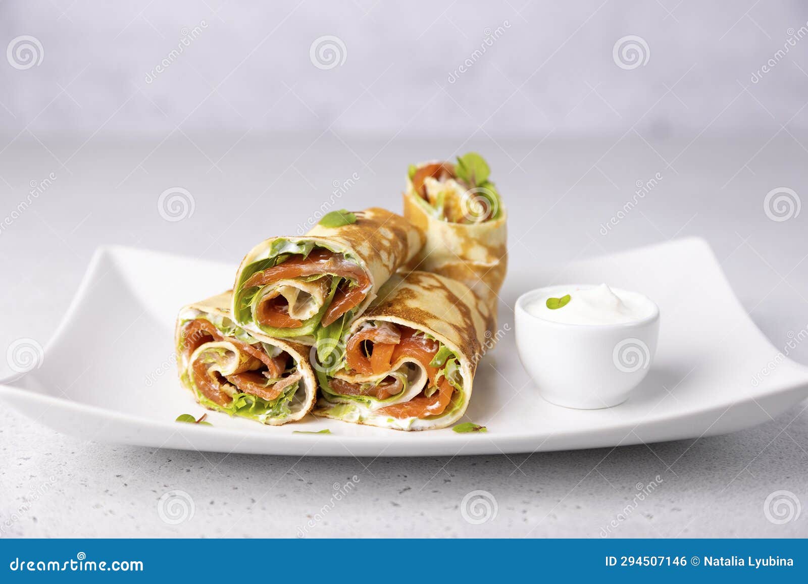 pancakes with salmon (trout), sour cream and greenstuff. thin, not sweet blinchiki stuffed with red fish.