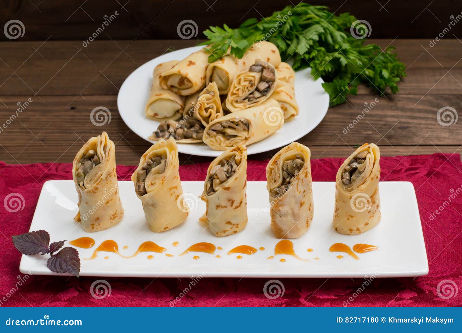 pancakes stuffed with mushrooms and sour cream on a rustic wooden table. top view. close-up