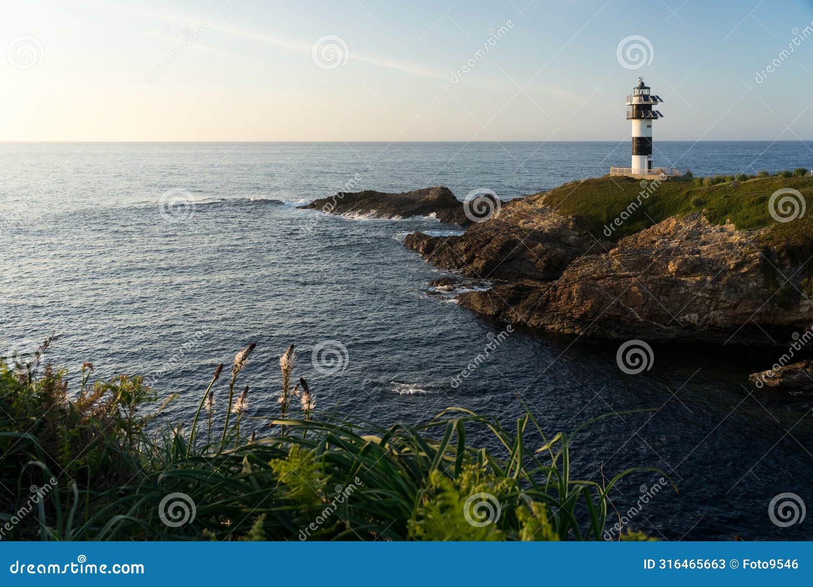 pancha island lighthouse at sunset in ribadeo coast, lugo province, galicia, spain