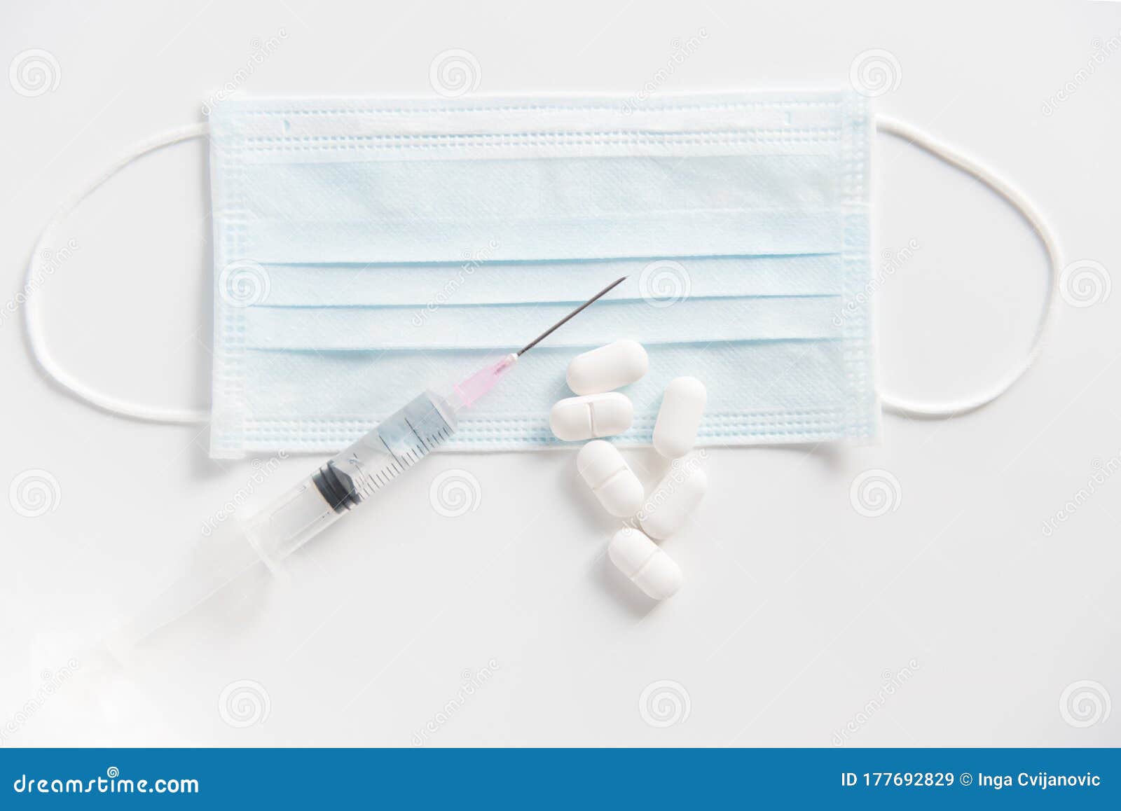 pills, drops and syringe on white background.