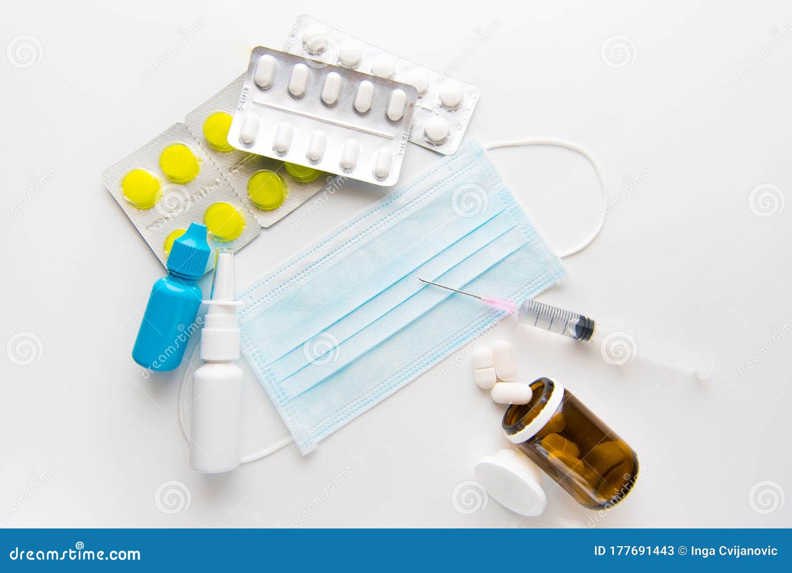 pandemic of coronavirus.  protective surgical mask,spray, pills, drops and syringe on white background.
