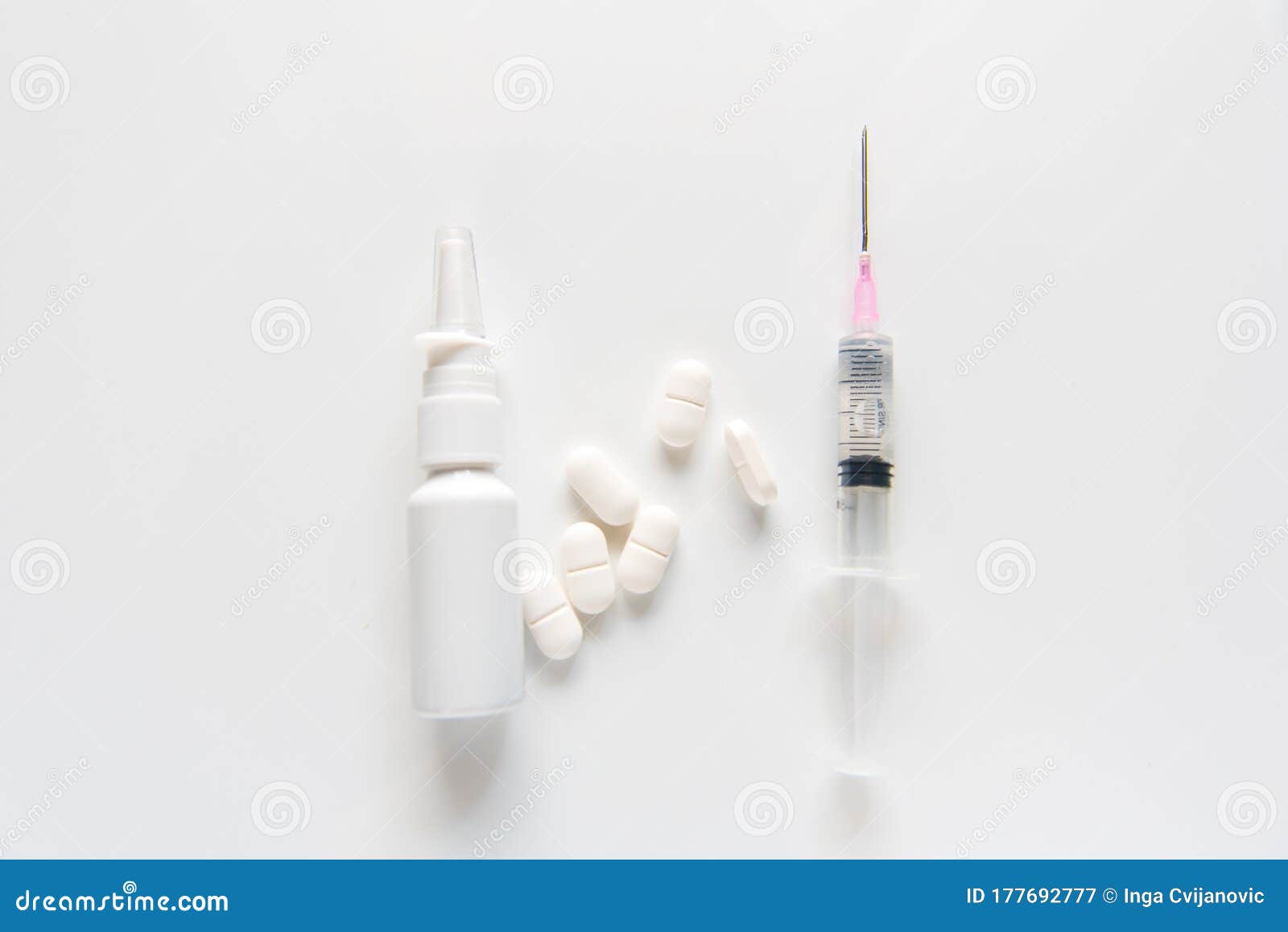 pray, pills, drops and syringe on white background .