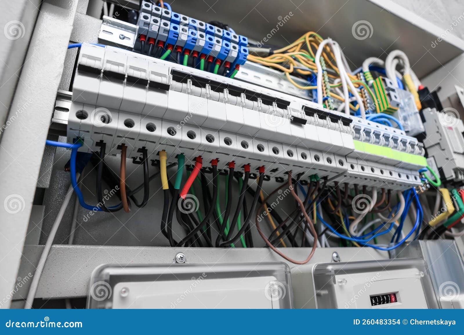 Panel with Electric Meters and Many Wires in Fuse Box Stock Photo