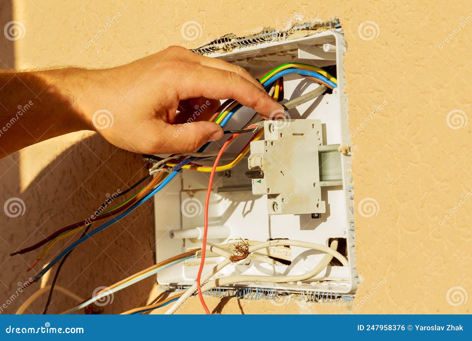 panel with electrical equipment. the electrician installs circuit breakers.