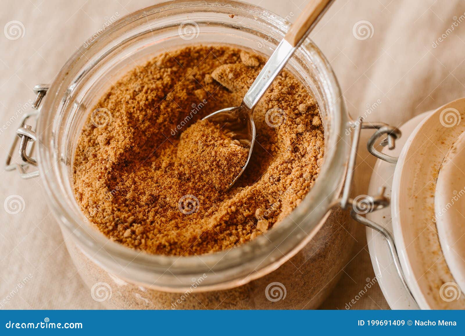 panela sugar background. close up view of raw cane sugar in a jar.