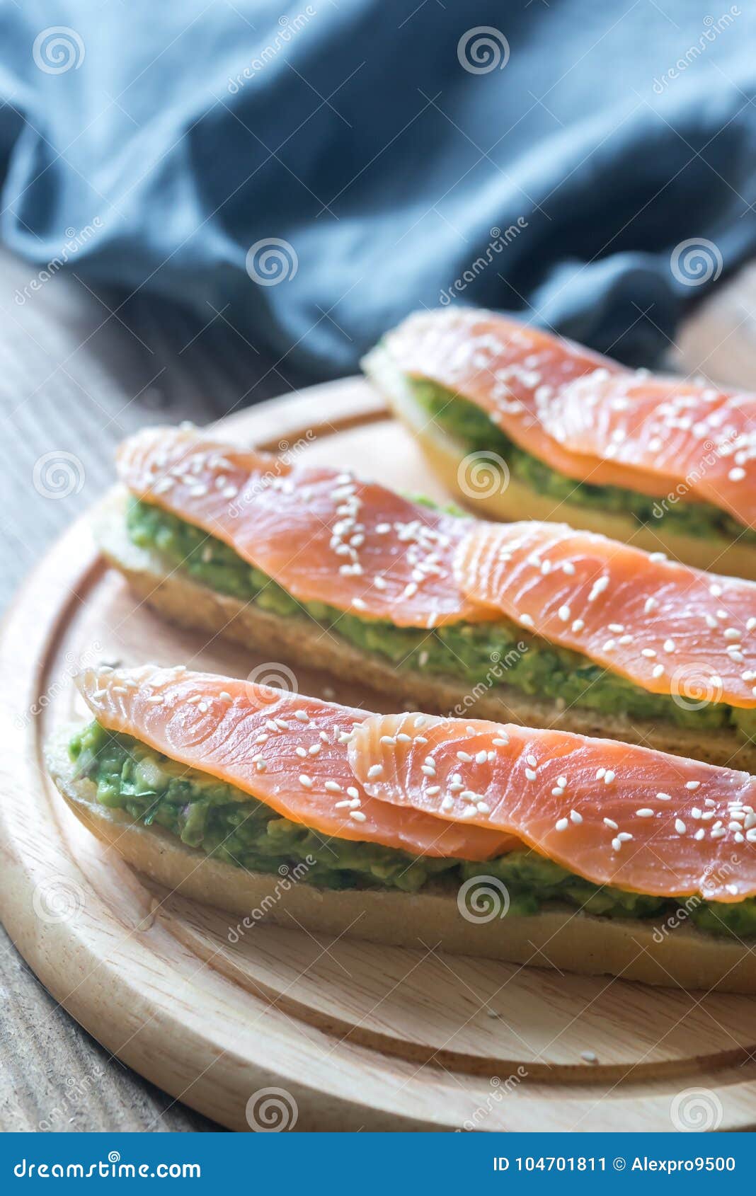 Pani tostati con guacamole ed il salmone affumicato sul bordo di legno