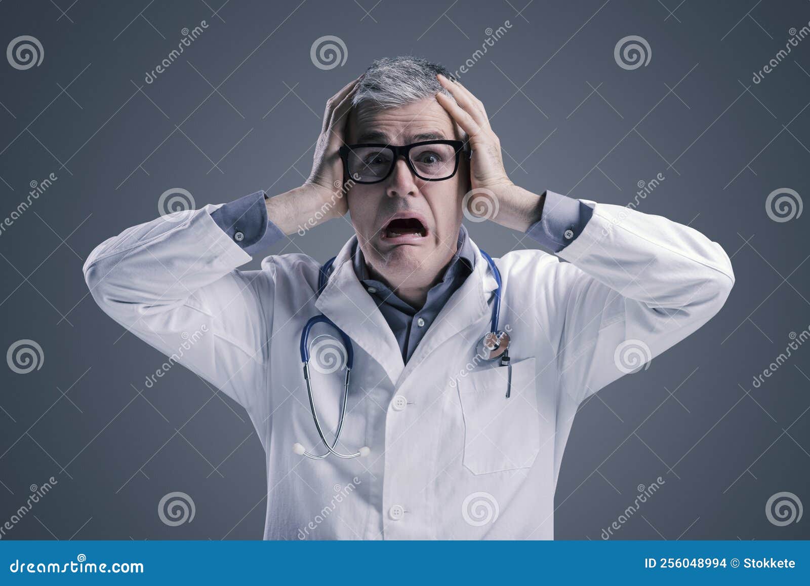 panicked doctor with head in hands