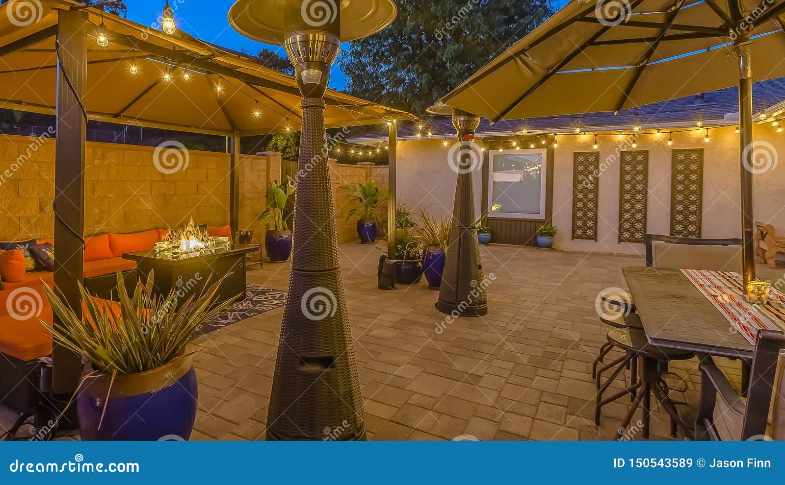 Panorama Frame Stone Brick Patio of a Home Illuminated with String