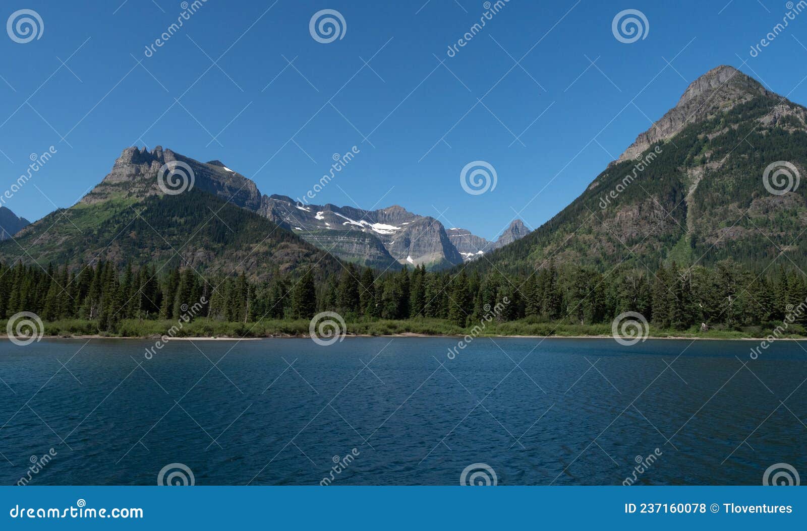 panorama of glacier national park`s goat haunt from upper waterton lake