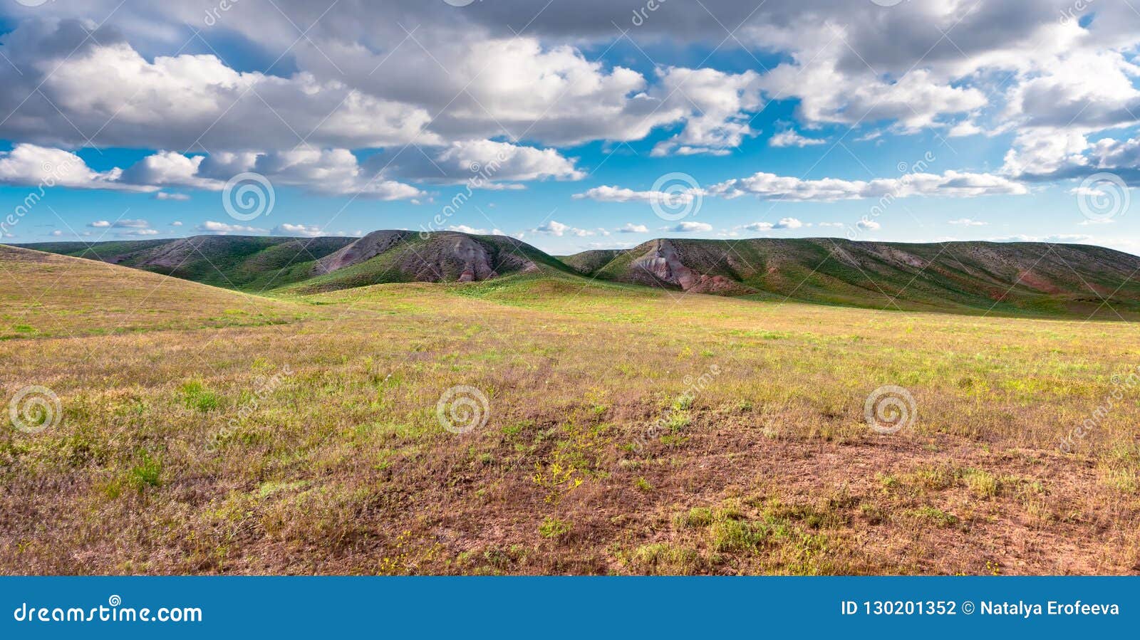 panorama hills in sunny day. vista scenic idylic landscape hills sun through the clouds meadow