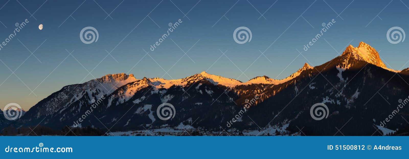 panorama of mountain chain with lighted summits