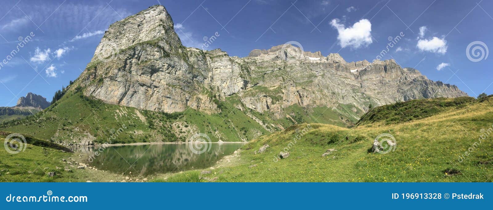 panorama of oberblegisee lake in swiss alps with blue sky and copy space