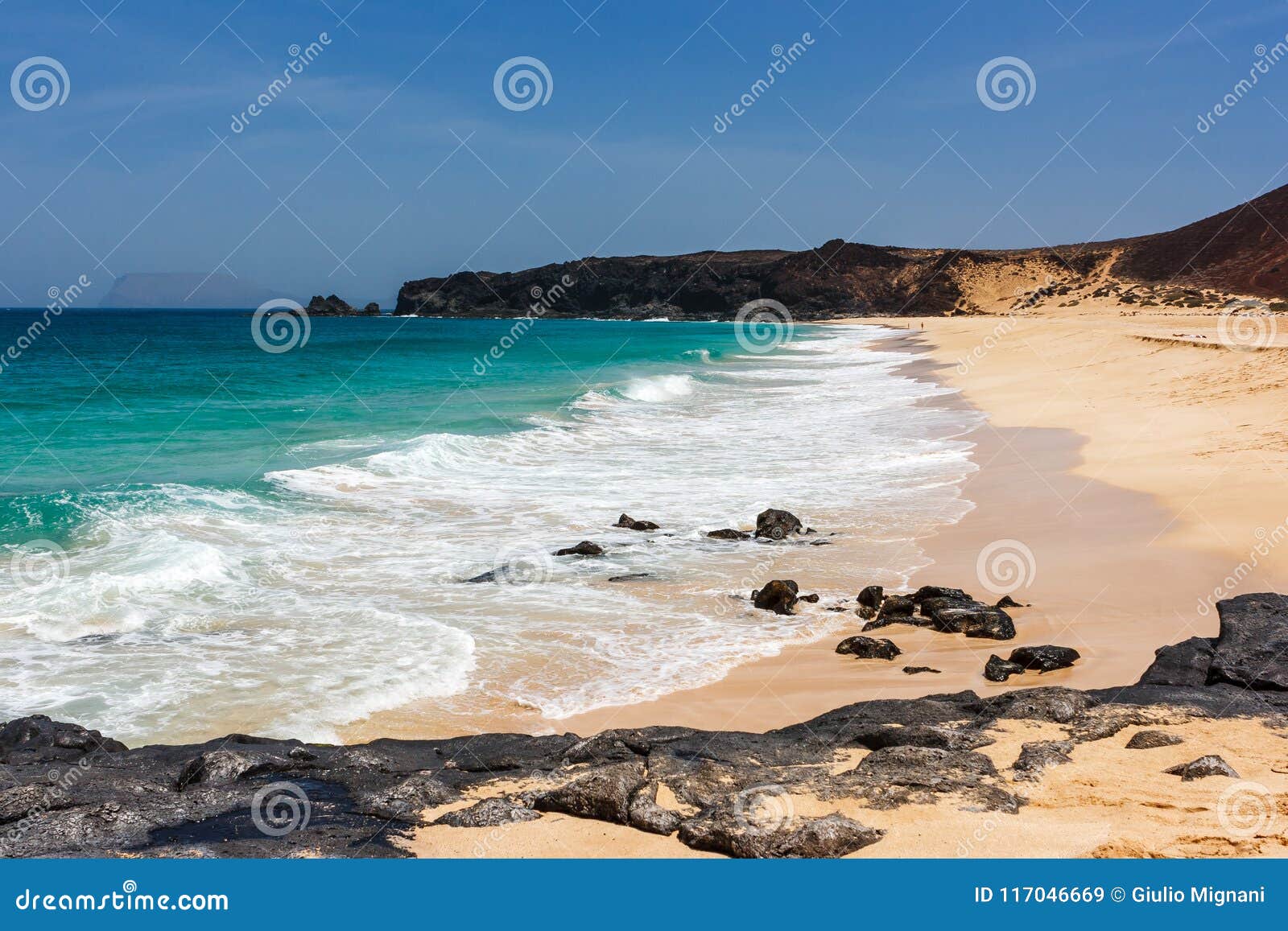 panorama of playa de las conchas beach with blue ocean and white sand. la graciosa, lanzarote, canary islands, spain.