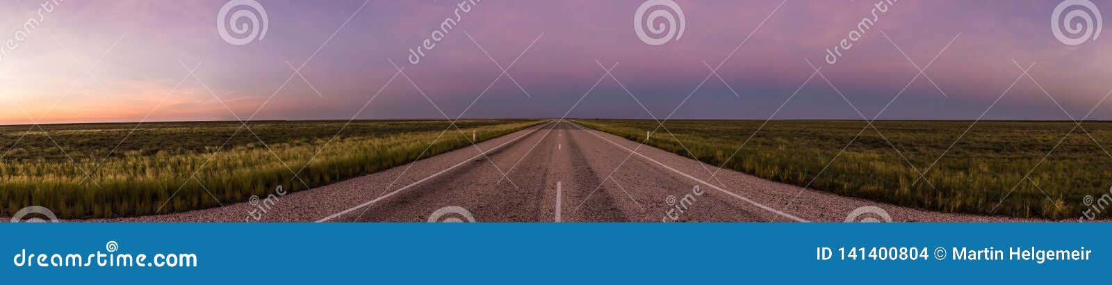 panorama of a straight road through the outback of australia, after a beautiful sunset, nothern territory