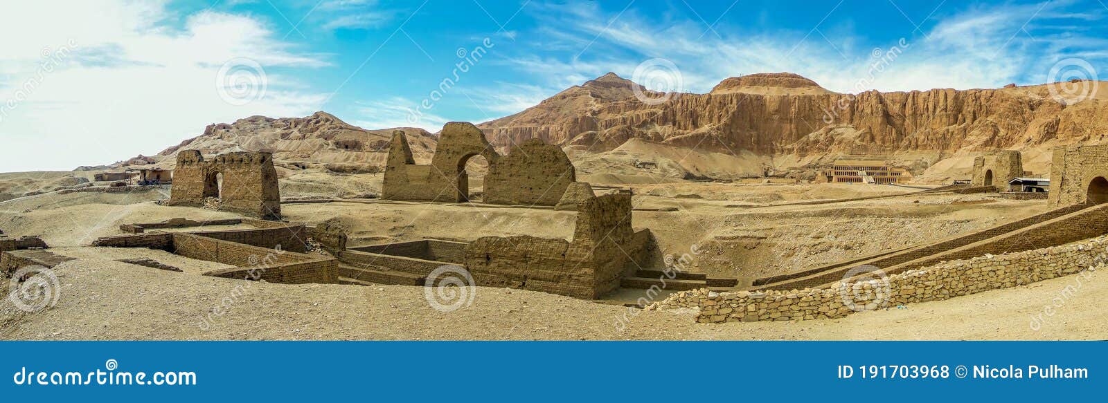 a panorama view on the east bank of the nile at luxor, egypt past ancient ruins towards the hatshepsut temple