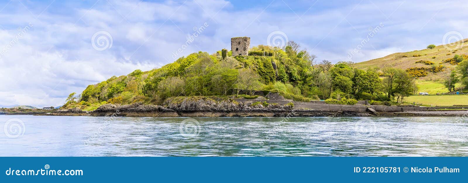 a panorama view from the firth of lorn towards dunollie castle at oban, scotland