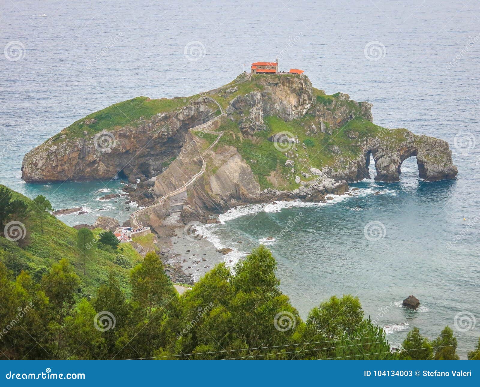 Panoramautsikt av San Juan de Gaztelugatxe, baskiskt land, Spanien. Gaztelugatxe är en holme på kusten av Biscay som tillhör kommunen av Bermeo, baskiskt land Den förbinds till fastlandet av en konstgjord bro