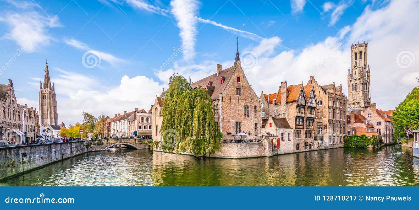 panoramic city view belfry tower and famous canal in bruges, belgium.