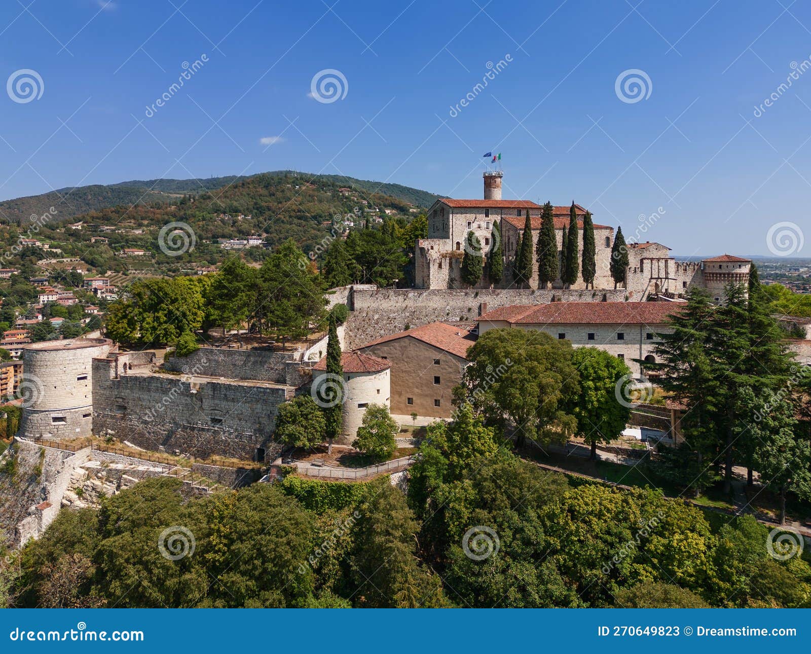 panoramic drone view of the western part of the historic castle on a hill (colle cidneo) in the city of brescia