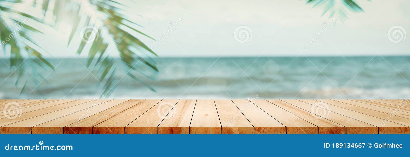 panoramic empty clean wood counter table top blur shinny white bokeh light on summer beach background for product morning scene