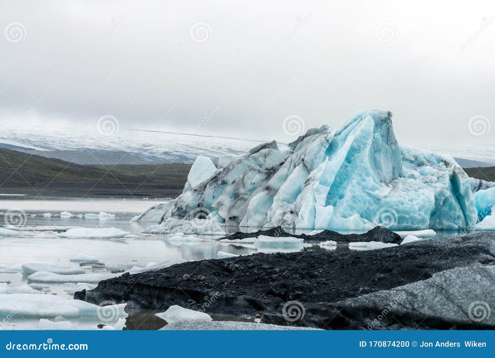 panoramic shot of fjallsarlon glacier lagoon at the end of vatnajokull glacier. icebergs with volcanic ash floating around in the