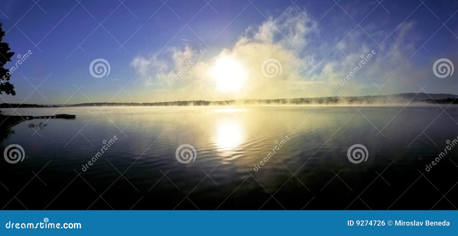 panoramic - sunrise over lake with haze