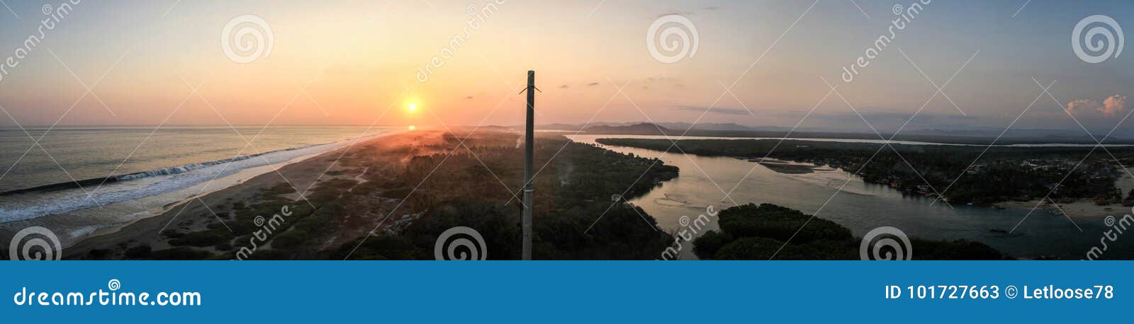 panoramic sunset on pacific ocean on one side and the the lagunas de chacahua on the other, chacahua, oaxaca, mexico