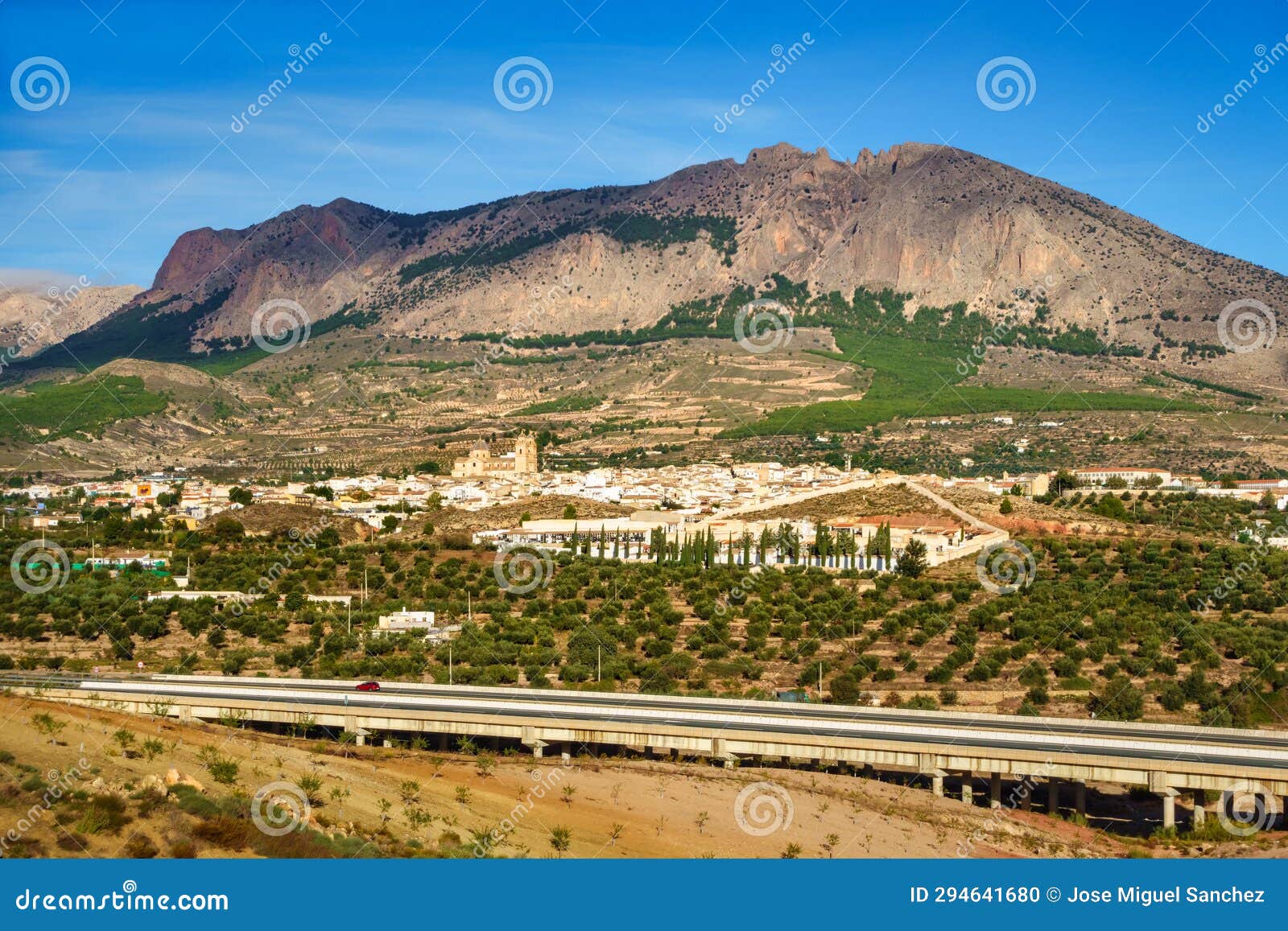 panoramic view of the andalusian white village next to the high mountains that surround it, velez rubio, almeria.