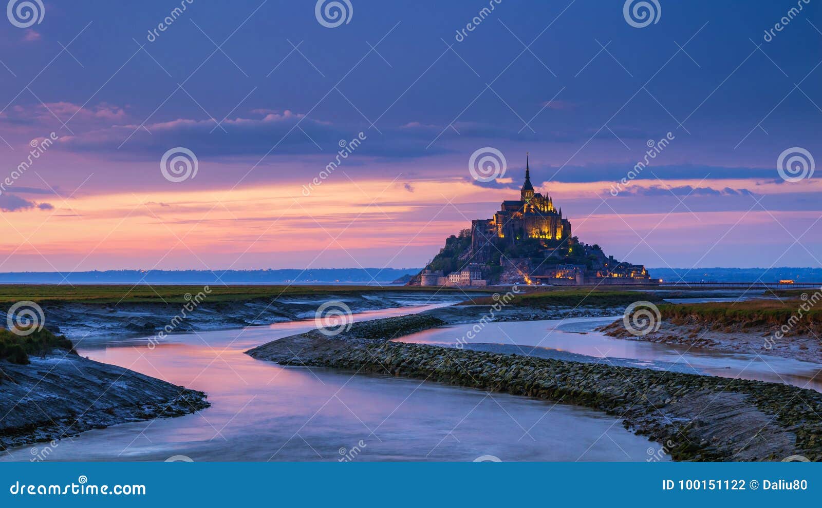 panoramic view of famous le mont saint-michel tidal island at sunset, normandy, northern france