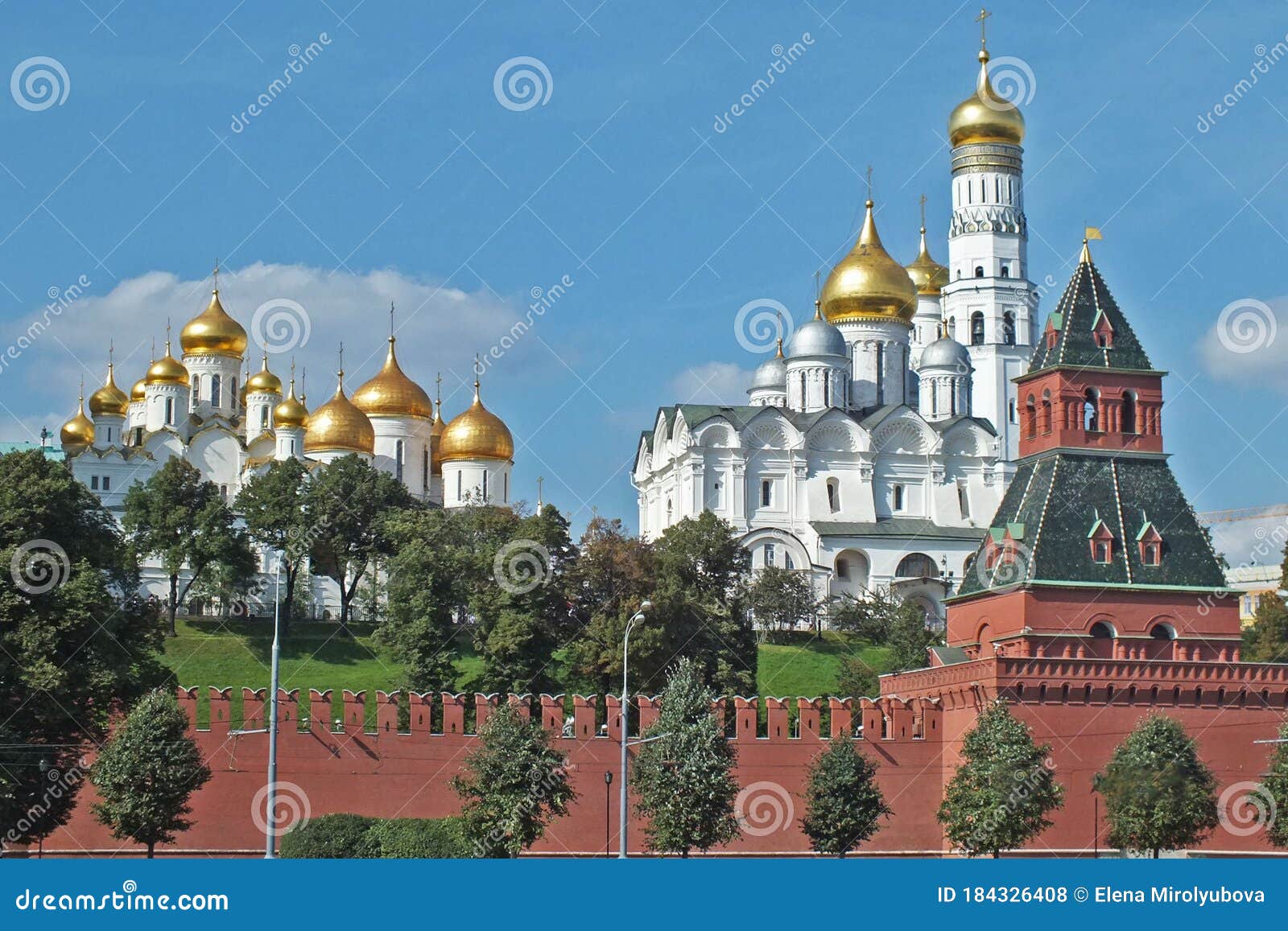 view of kremlin wall with tower and cathedrals photo made from opposite bank of the river moscow