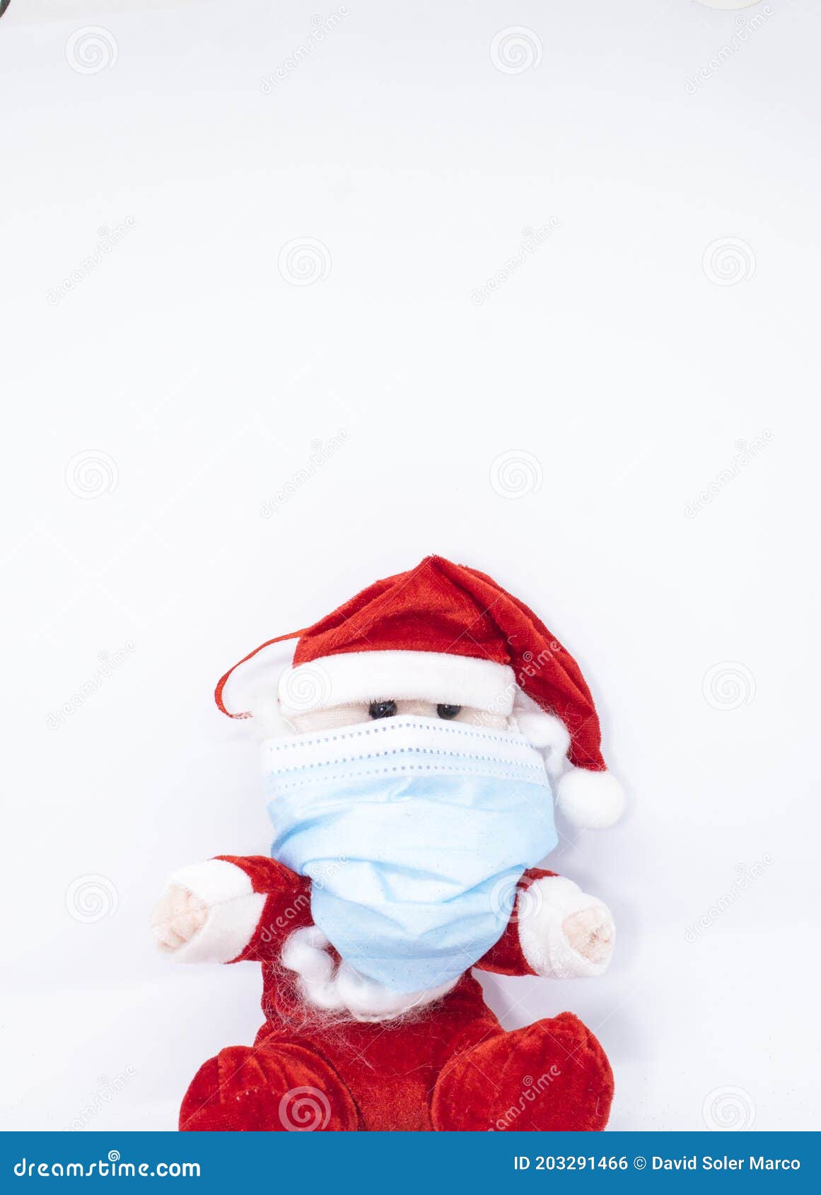 homemade cotton santa claus play with a covid-19 or coronavirus protection mask