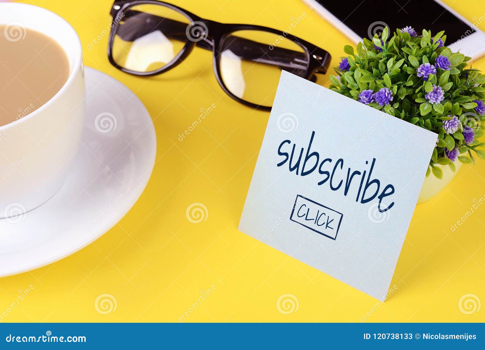 Paper card with `subscribe` text and coffee with phone on a yellow background.