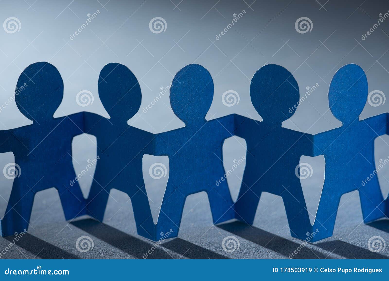 Paper Dolls Holding Hands Symbolizing Union and Team Stock Image