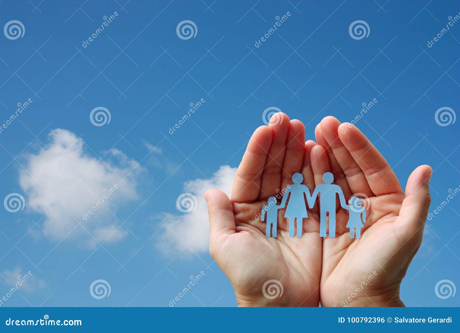 paper family in hands on blue sky background welfare concept