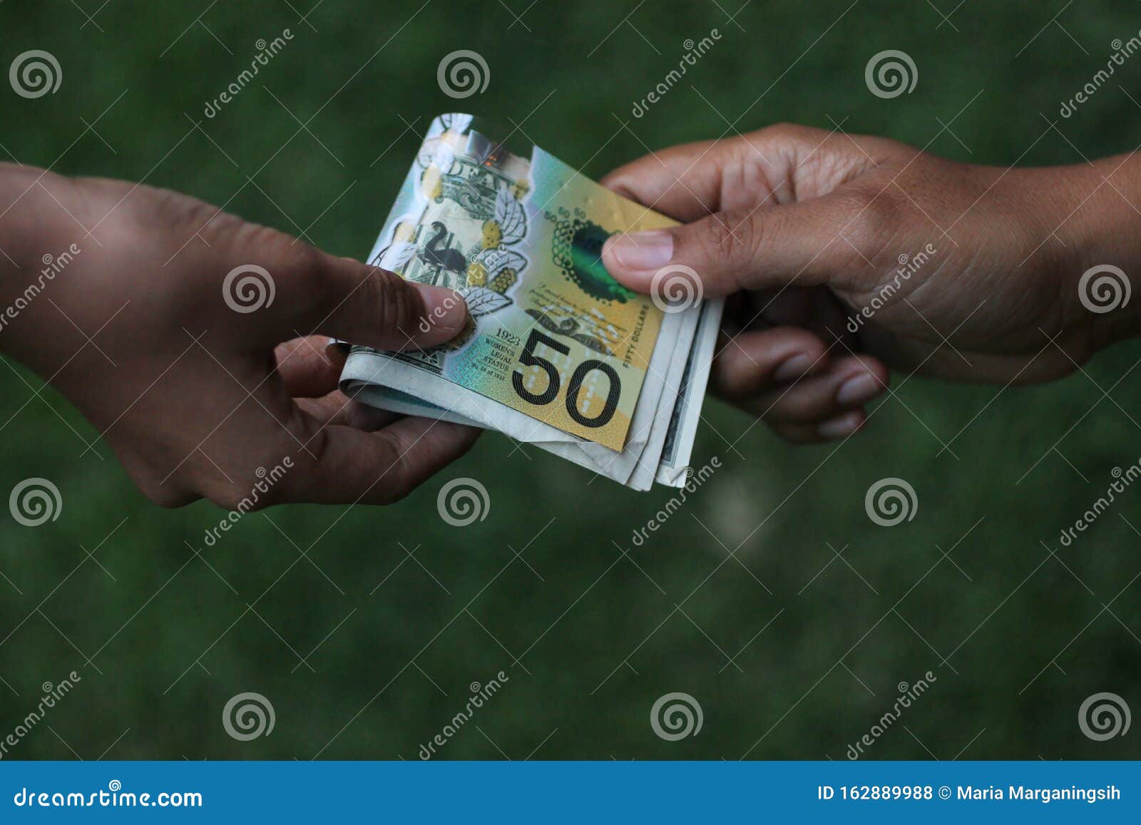 Paper Money in Hand. Two Hands of Young Woman or Man AUD Australian Dollar on Green Background. Pay Day Concept. Stock Photo - Image of budgeting: 162889988