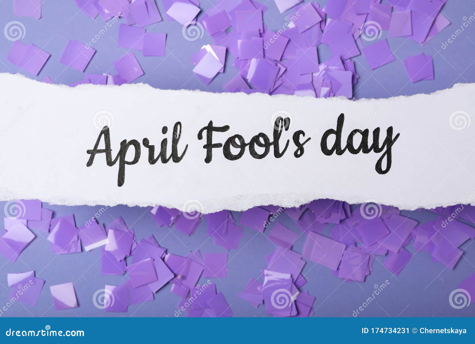 Paper Note with Phrase APRIL FOOL`S DAY and Confetti on Lilac