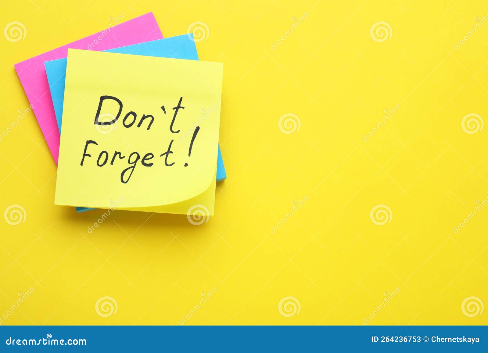 paper note with phrase don` t forget on yellow background, top view. space for text