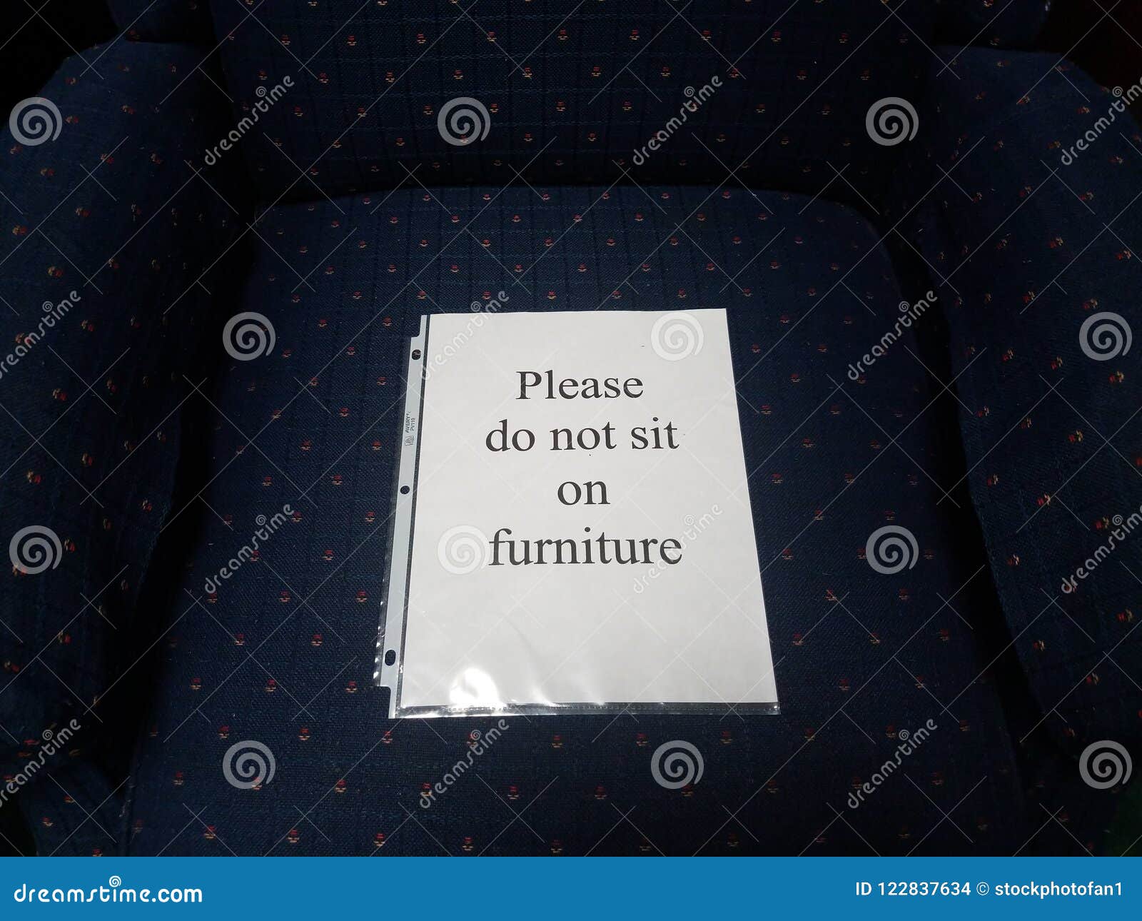 Paper Please Do Not Sit On Furniture Sign On Blue Chair Stock