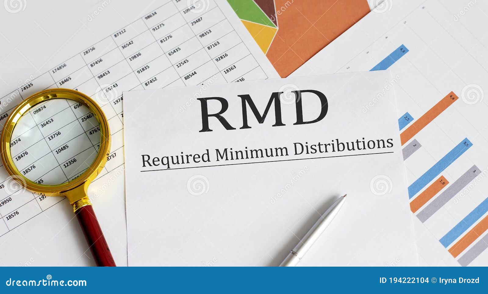 paper with required minimum distributions rmd on a table with pen ,chart , magnifier