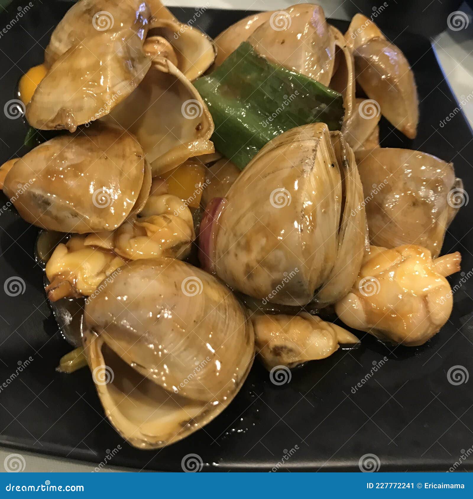 pipis seafood on black plate.