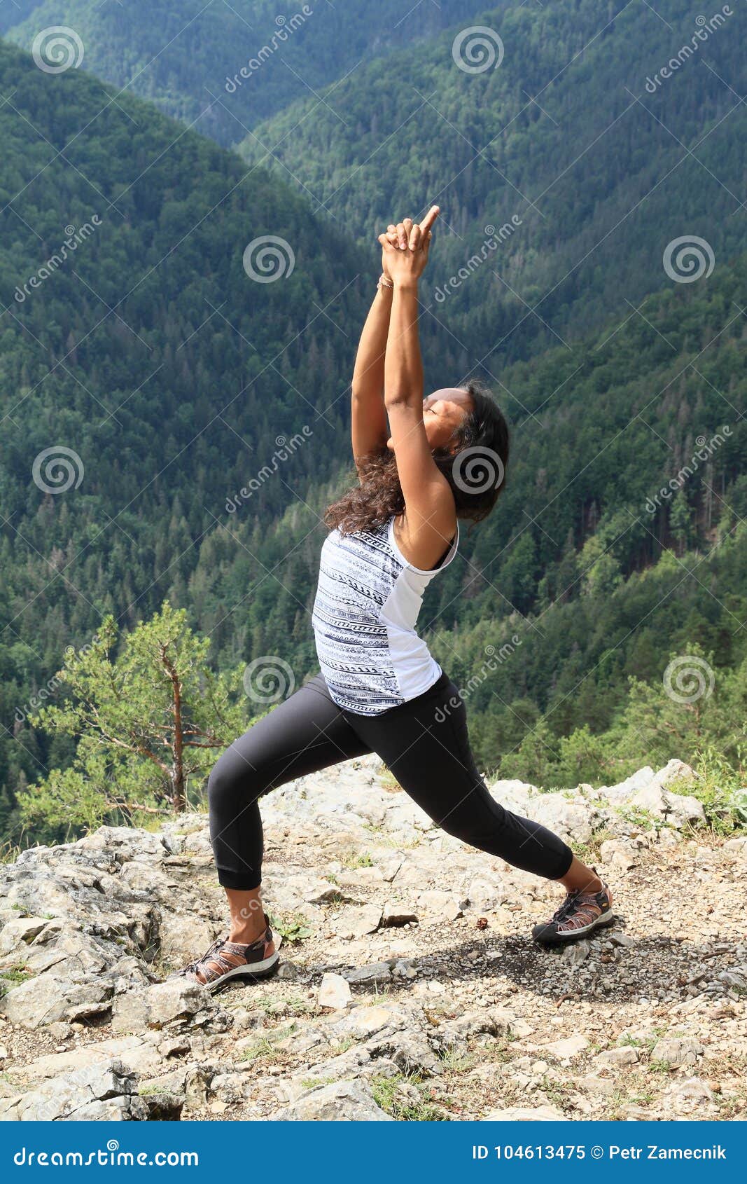 papuan young woman tropical girl exercising yoga pose anjaneyasana front hills forest viewpoint slovak paradise 104613475